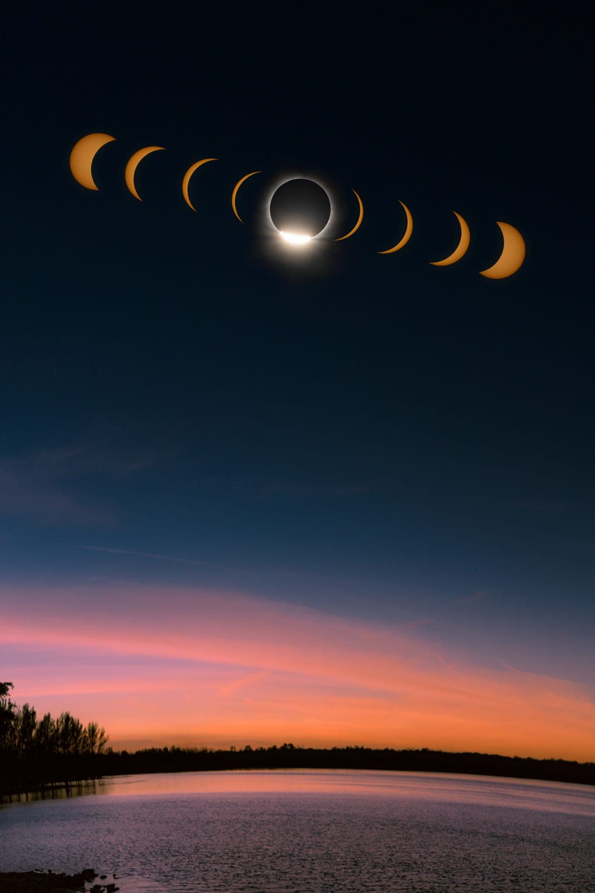 Total solar eclipse reflected in a lake